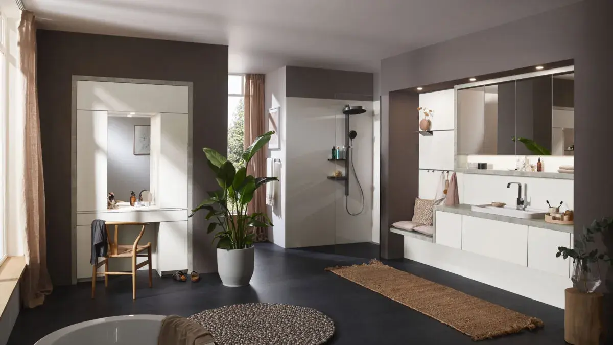 Modernes Badezimmer mit großer Dusche, weißen Möbeln, Spiegel und Pflanze im Topf.